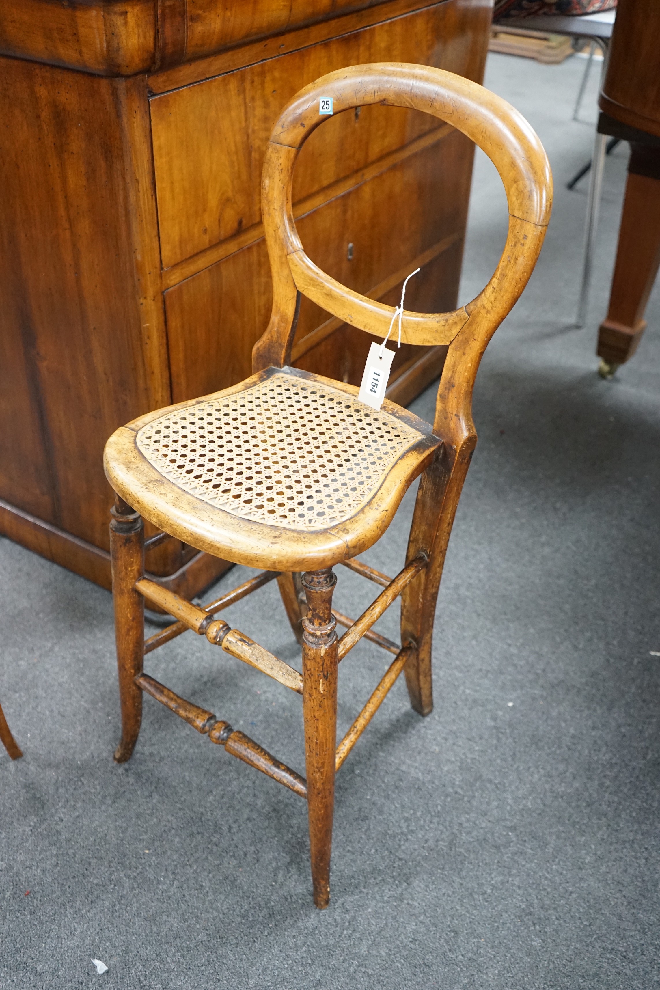 A Victorian caned beech child's correction chair and an Edwardian inlaid mahogany oval occasional table